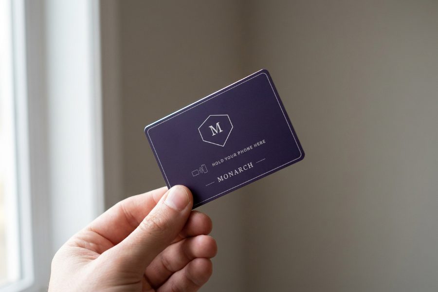 A Monarch tap card held in a hand