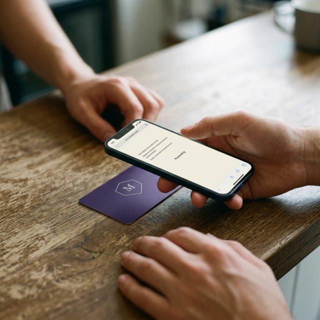 A phone being tapped on a Monarch card